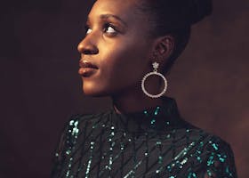 Stunning portrait of an African woman in elegant fashion, showcasing sparkling jewelry and style.